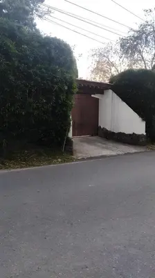 a house with a garage next to a street at Pietrasanta Home in Rionegro