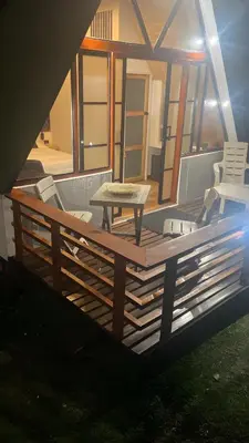 a deck with a table and chairs on a house at Pietrasanta Home in Rionegro