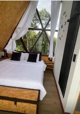 a bedroom with two beds and a large window at Pietrasanta Home in Rionegro