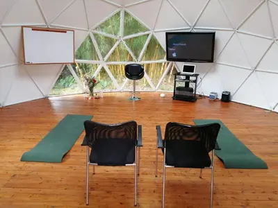 a room with two chairs and a screen in a tent at Pietrasanta Home in Rionegro