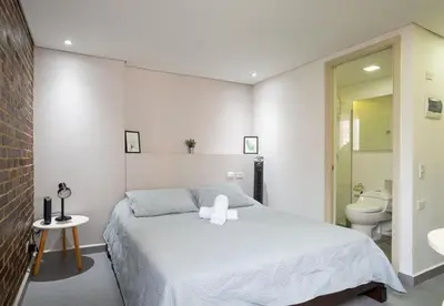 a bedroom with a bed and a sink and a toilet at Beautiful apt in Poblado-Tesoro Near Provenza! in Medellín