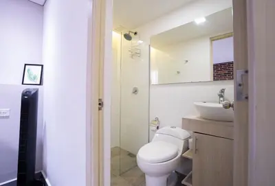 a bathroom with a toilet and a sink at Beautiful apt in Poblado-Tesoro Near Provenza! in Medellín