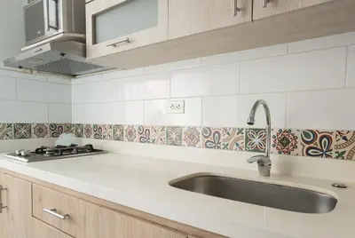 a white kitchen with a sink and a stove at Beautiful apt in Poblado-Tesoro Near Provenza! in Medellín