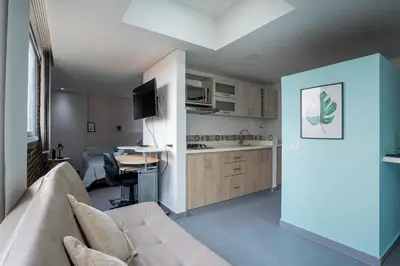 a living room with a couch and a kitchen at Beautiful apt in Poblado-Tesoro Near Provenza! in Medellín