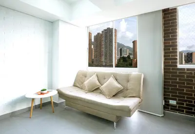 a living room with a couch and a window at Beautiful apt in Poblado-Tesoro Near Provenza! in Medellín