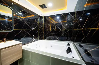 a bathroom with a bath tub and a sink at Hotel LAX78 in Medellín