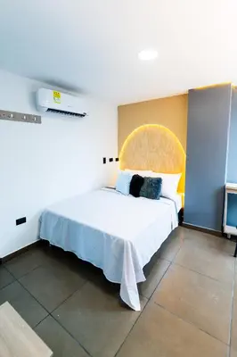 a bedroom with a large white bed in a room at Hotel LAX78 in Medellín