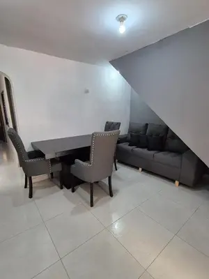 a dining room with a table and chairs and a couch at BONITO y ELEGANTE APARTAMENTO in Medellín