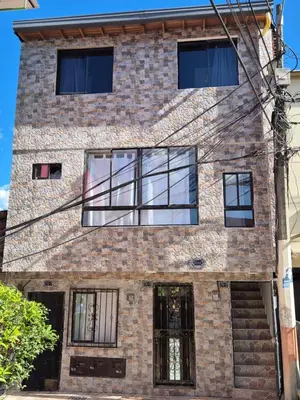a brick building with glass windows on it at BONITO y ELEGANTE APARTAMENTO in Medellín