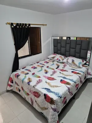 a bed with a quilt on it in a bedroom at BONITO y ELEGANTE APARTAMENTO in Medellín