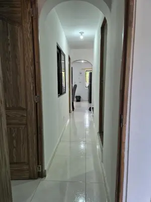 a hallway with white walls and an archway at BONITO y ELEGANTE APARTAMENTO in Medellín