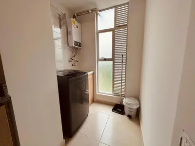a small kitchen with a refrigerator and a window at Espectacular vista, apto de lujo, piscina, gym in Manizales