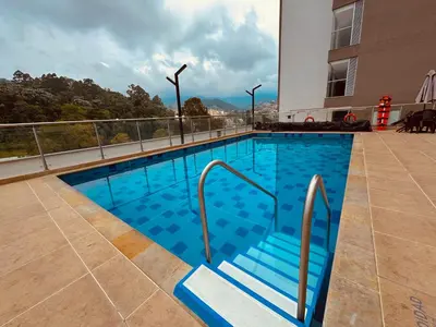 a swimming pool on top of a building at Espectacular vista, apto de lujo, piscina, gym in Manizales