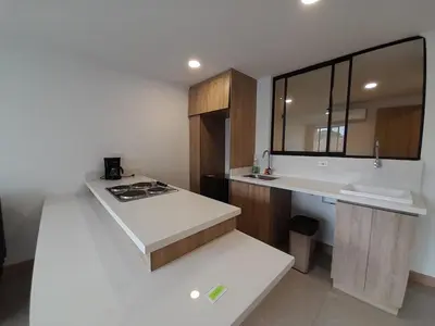a white kitchen with a counter and a sink at Medellin laureles mejor ubicación in Medellín
