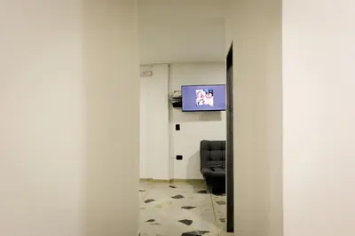 a room with a chair and a television in it at Apartamento Rosales in Medellín