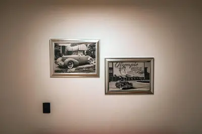 three framed photographs of a car on a wall at Apartamento Rosales in Medellín