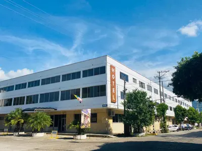 a white building with a sign on the side of it at Hotel Mall Santana Del Río in La Dorada