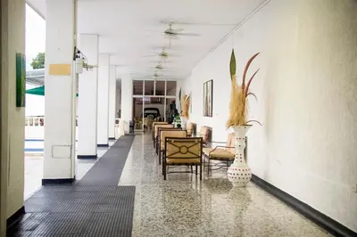 a hallway with chairs and vases in a building at Hotel Mall Santana Del Río in La Dorada