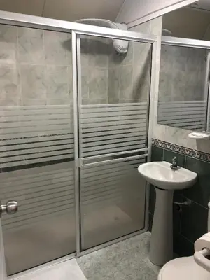 a bathroom with a shower and a sink at Hotel Mall Santana Del Río in La Dorada