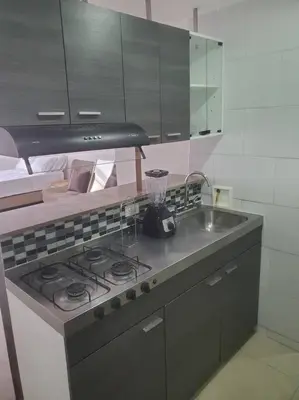 a kitchen with a stove and a sink at Mde Escape in Medellín