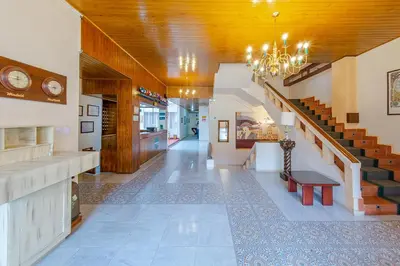 a hallway with a staircase and a stair case at Hotel Ana Carolina in Manizales