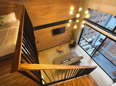 an overhead view of a room with a bed and a desk at Indust in Medellín