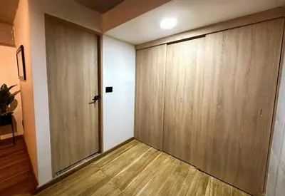 a room with a door and a wooden wall at Indust in Medellín