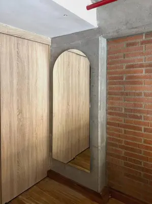 a room with a brick wall and an archway at Indust in Medellín