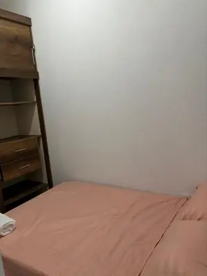 a bedroom with a bed and a book shelf at Casa santorini in Puerto Triunfo