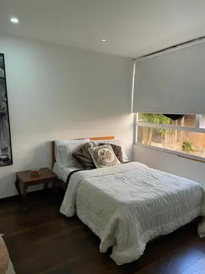 a white bedroom with a bed and a window at Athos Hotel Boutique in Bolivia