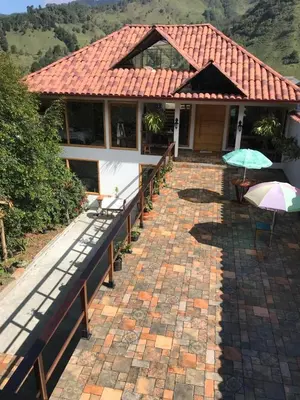 a house with two umbrellas on a brick walkway at Athos Hotel Boutique in Bolivia