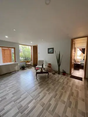 a large living room with a couch and a table at Athos Hotel Boutique in Bolivia