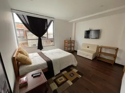 a bedroom with a bed and a window at Athos Hotel Boutique in Bolivia
