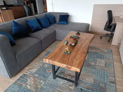 a living room with a couch and a wooden coffee table at Penthouse Estadio Medellín in Medellín