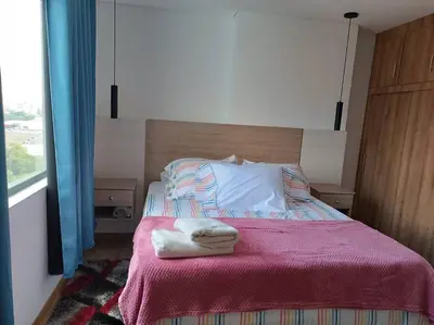 a bedroom with a bed with two towels on it at Penthouse Estadio Medellín in Medellín