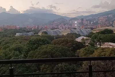 a view of a city with trees and buildings at Penthouse Estadio Medellín in Medellín