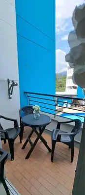 a patio with two chairs and a table and a window at Mi Paraíso in Sopetran