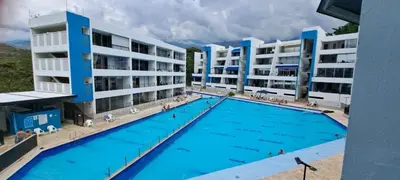 a large swimming pool in front of buildings at Mi Paraíso in Sopetran