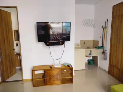 a living room with a tv on a wall at Mi Paraíso in Sopetran