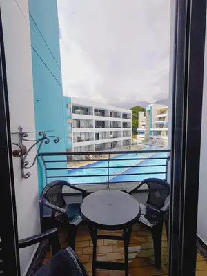 a table and chairs on a balcony with a view of a building at Mi Paraíso in Sopetran
