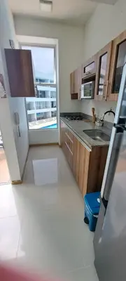 a kitchen with a sink and a refrigerator and a window at Mi Paraíso in Sopetran