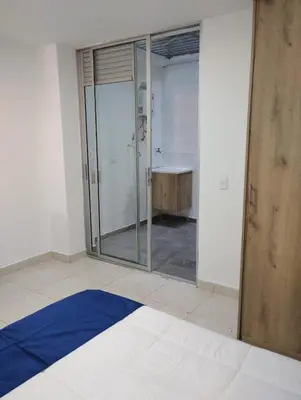 a bathroom with a glass shower and a tub at Hermoso aparta estudio en Medellin in Medellín