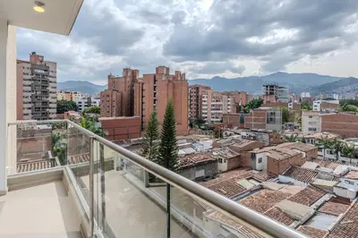 a balcony with a view of a city at Apartamento en maravilloso Laureles con piscina 801 in Medellín