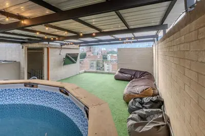 a large room with a swimming pool in a building at Apartamento en maravilloso Laureles con piscina 801 in Medellín