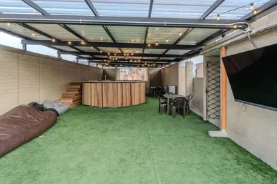 a room with a stage and a table and chairs at Apartamento en maravilloso Laureles con piscina 801 in Medellín
