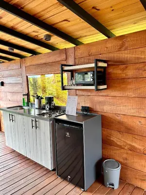 an outdoor kitchen with a counter and a stove at Ecoedén glamping in Guatapé