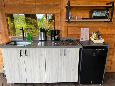 a kitchen with a sink and a stove at Ecoedén glamping in Guatapé