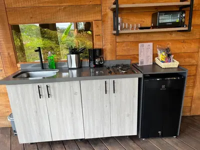 a kitchen with a counter and a sink and a stove at Ecoedén glamping in Guatapé