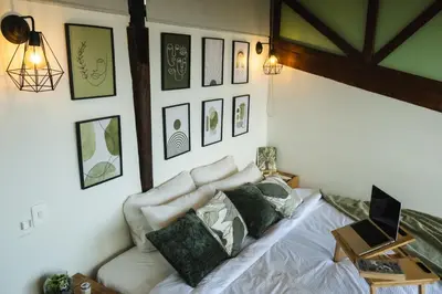 a bedroom with a bed with a laptop on it at Refined cabin, panoramic views, steps from Jericó in Jericó