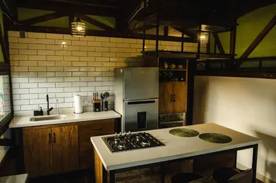 a kitchen with a stove and a refrigerator at Refined cabin, panoramic views, steps from Jericó in Jericó